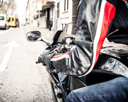 person riding motorcycle, view from over the shoulder of rider